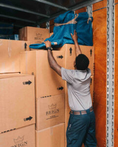 Man Storing Boxes and Furniture.