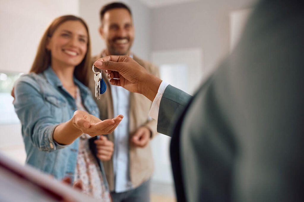 A couple getting the keys to their new home