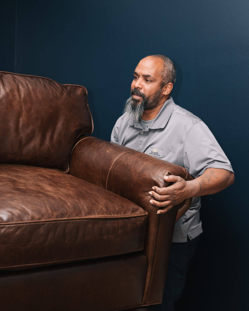A man helping to move a couch