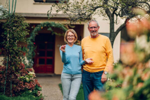 A senior couple holding a house key